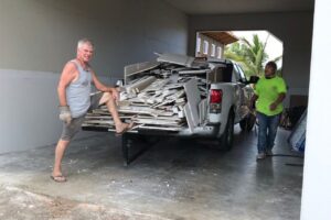 A messy pickup load of drywall, stacked heavy.